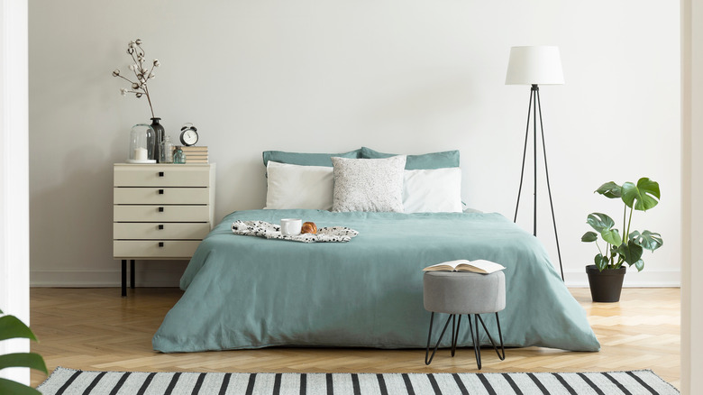 white bedroom with blue bedding