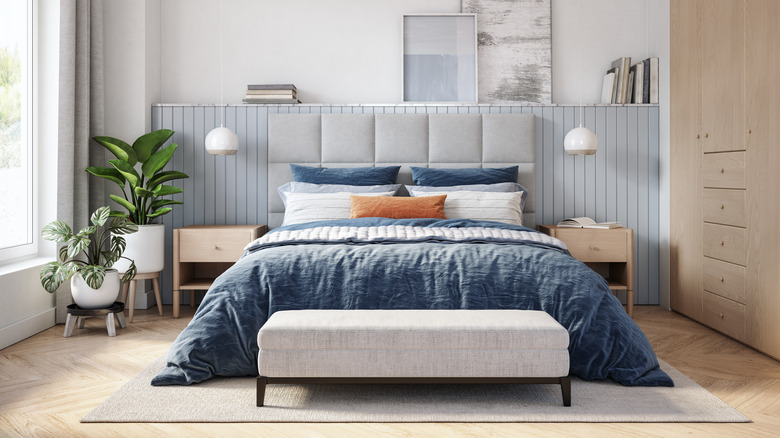 relaxing blue bedroom with rug under bed