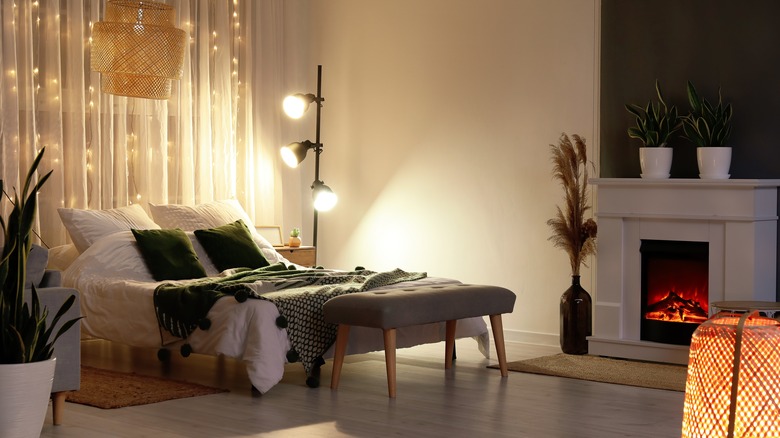 bedroom with string lights, standing lamp, and ceiling light