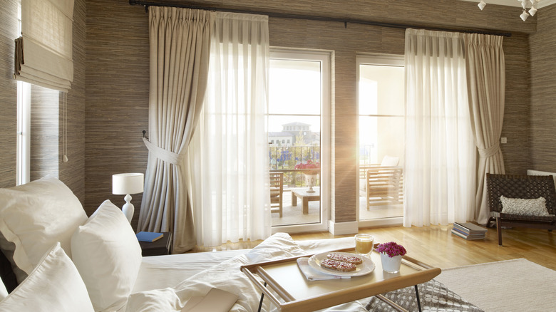 bedroom with blinds, drapes, and sheer panels