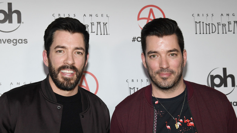 The Property Brothers smiling being photographed at a red carpet event