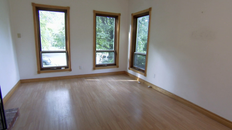 An empty dining room with wooden floors