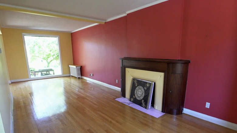 A living room with bright red and yellow walls