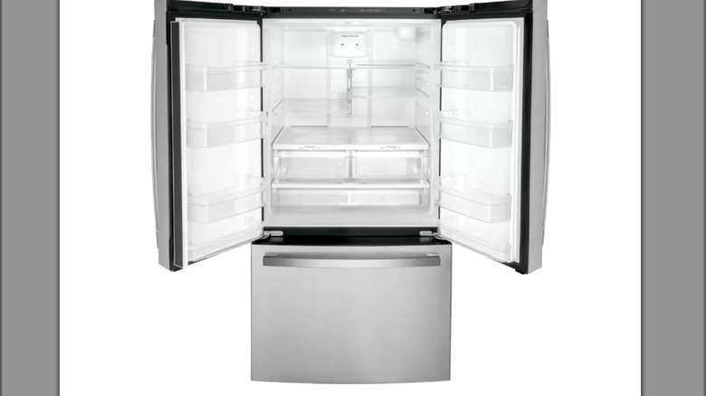 GE brand stainless steel fridge with both doors open.