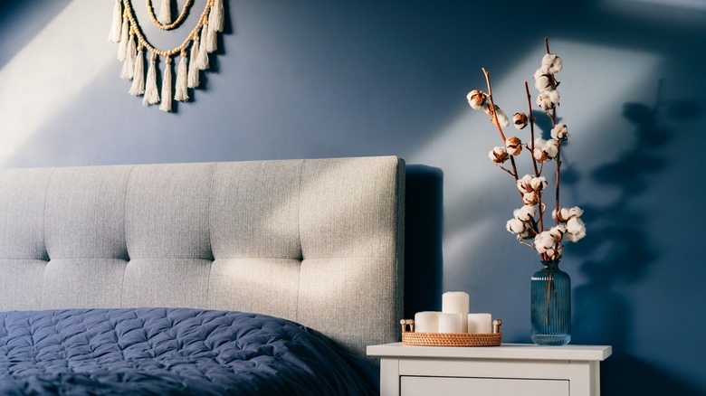 Blue walls with gray headboard