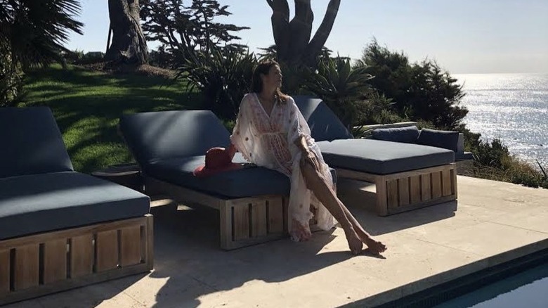 Cindy Crawford lounging by pool