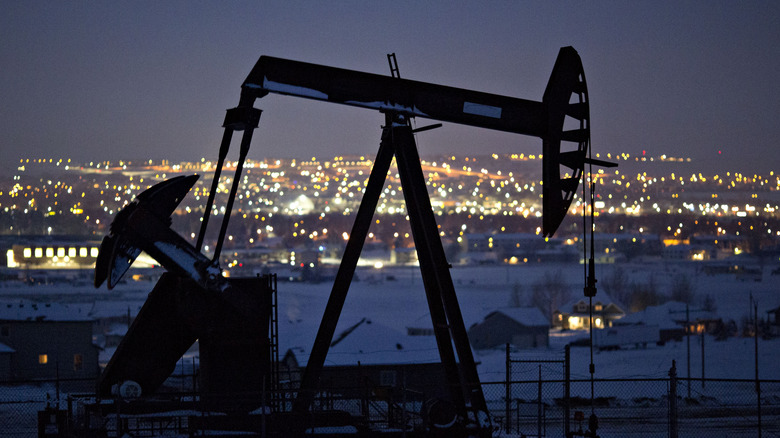 Williston city and pumpjack at night