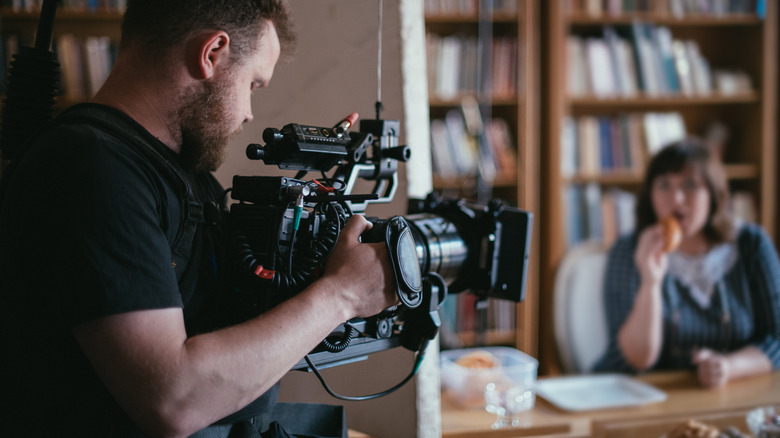 man holding film camera