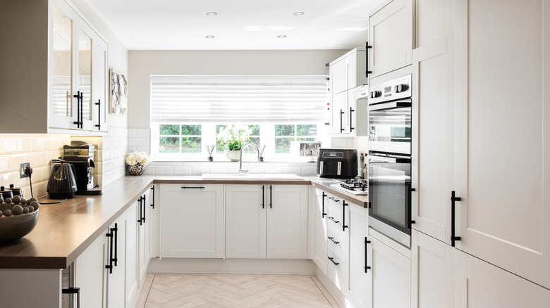 Kitchen with white cabinets and black hardware