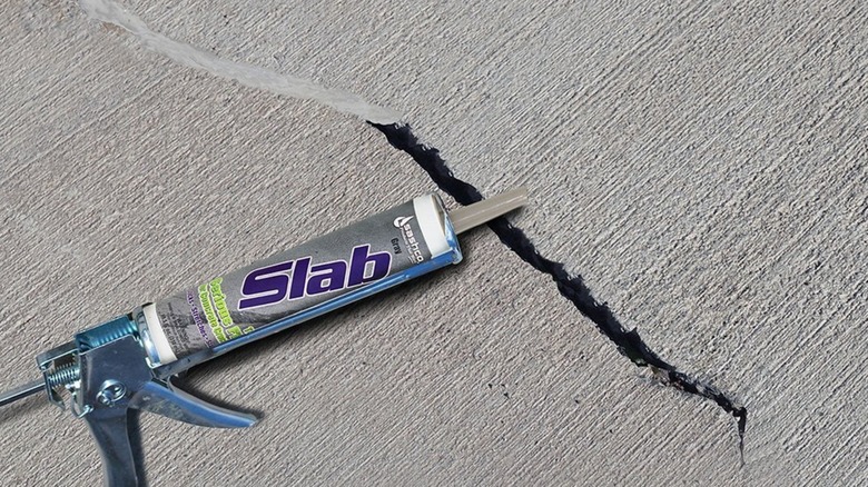 Sashco Slab Repair Sealant applicator over concrete crack