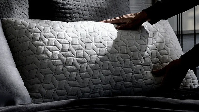 Person placing Luxome pillow