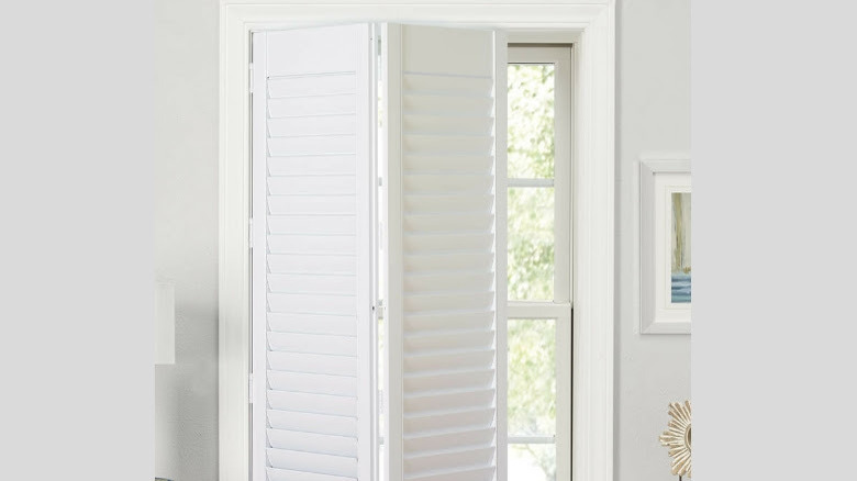 White wooden shutters on window 