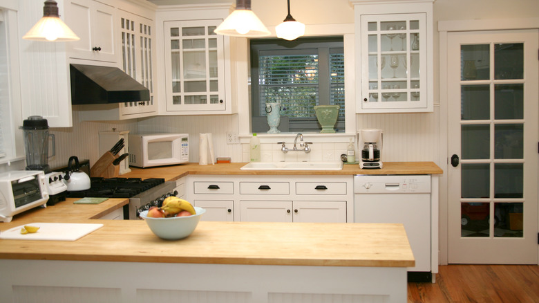 Butcher block counters in white kitchen