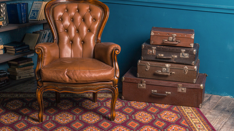 vintage suitcases next to chair