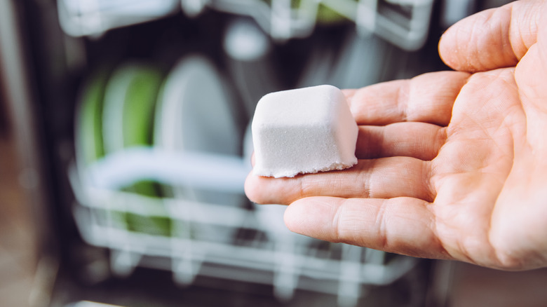 hand holding dishwasher pod