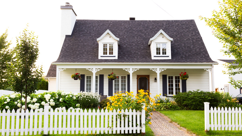 House with white fence and blooming garden