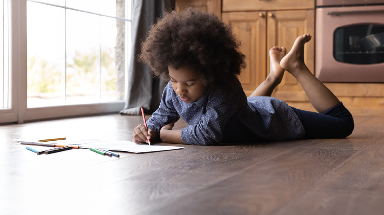 child drawing on luxury vinyl floor