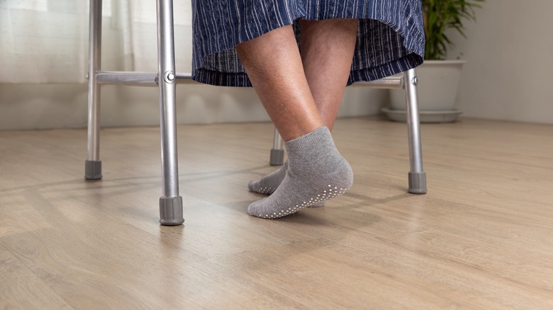 Woman using walker on floor