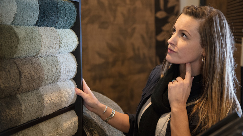 woman looking at carpet samples