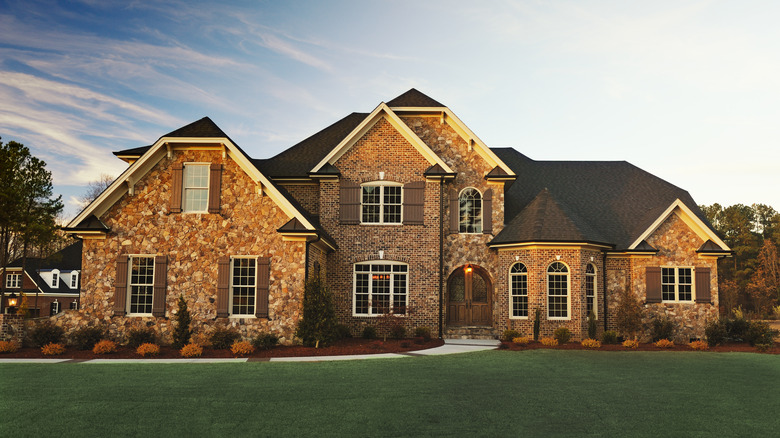 Brown brick home with brown door