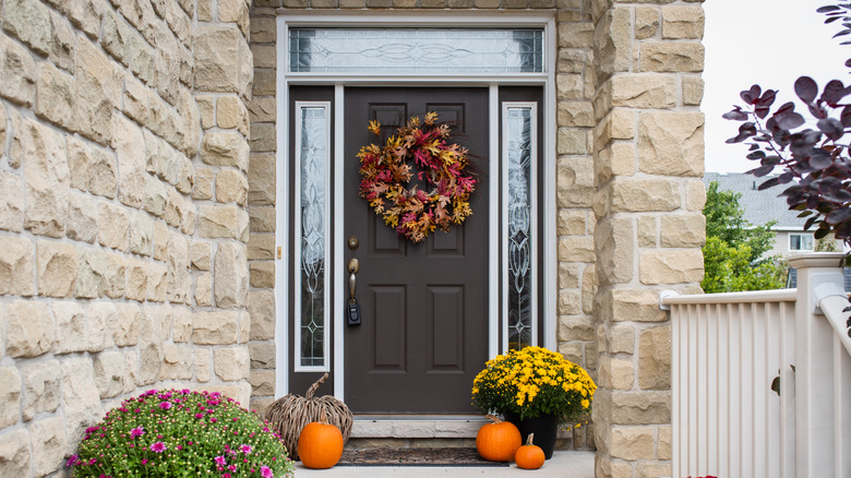 Tan brick house with grey door