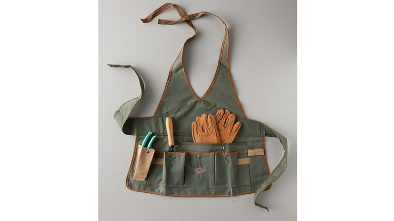 Green apron with garden tools