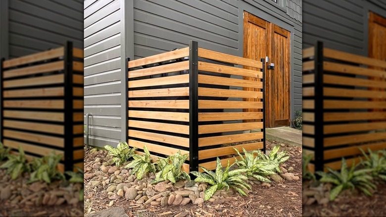 Privacy screens covering a utility box outside a home