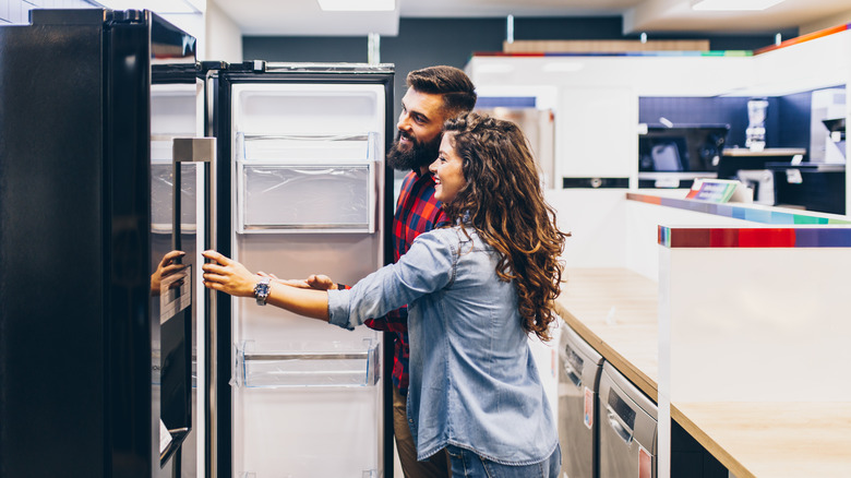 couple fridge shopping