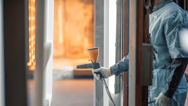 A person using a paint sprayer