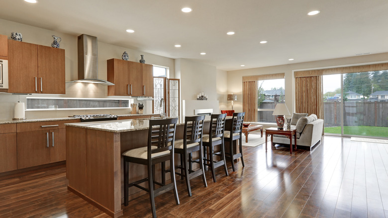 An open floor plan kitchen and living room with hardwood floors