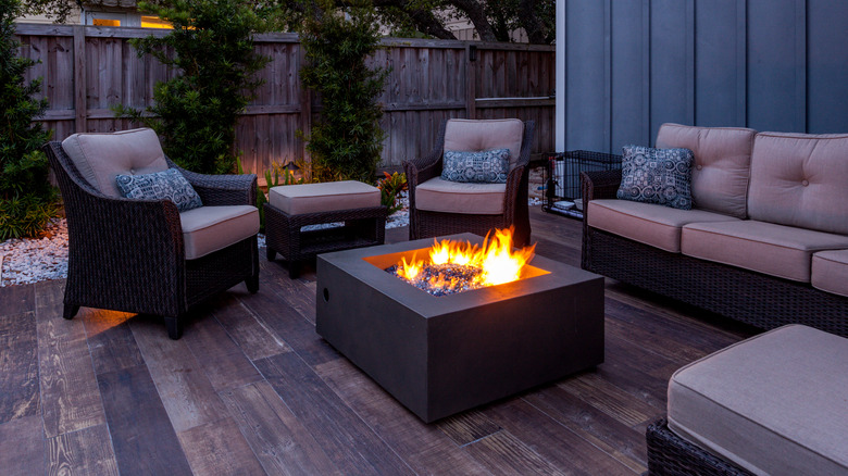 Patio chairs and couch with fire pit