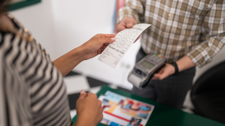 two people holding store receipt 