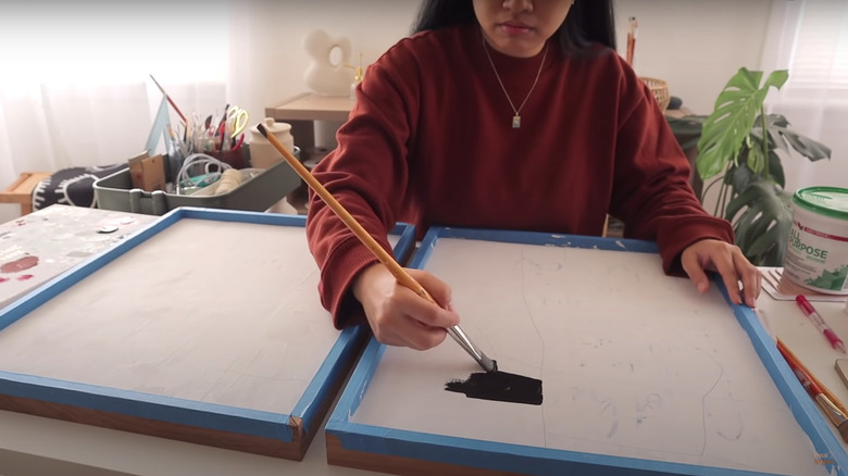 woman painting canvases at home