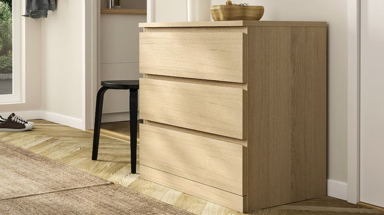 The MALM three drawer dresser near white wall