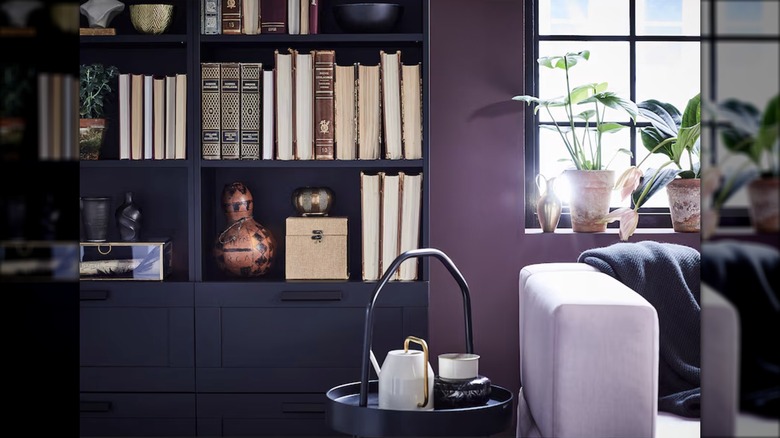 Black BRIMNES bookcases display books and decorative items in a living room