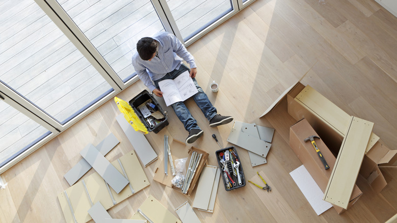 An ariel view of a person assembling IKEA cabinet