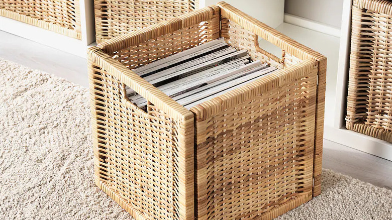 A rattan storage box near a shelf