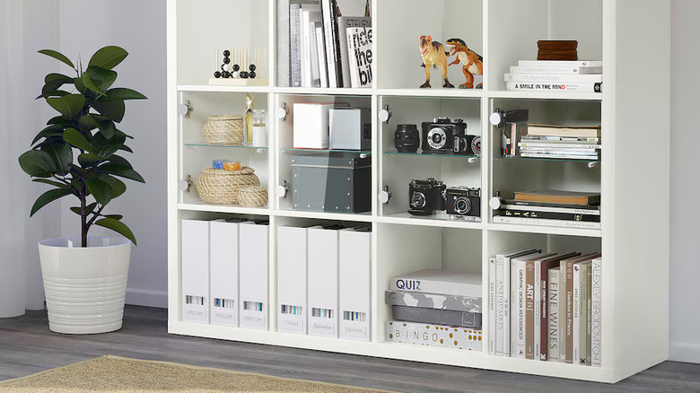 A KALLAX storage unit with glass shelves