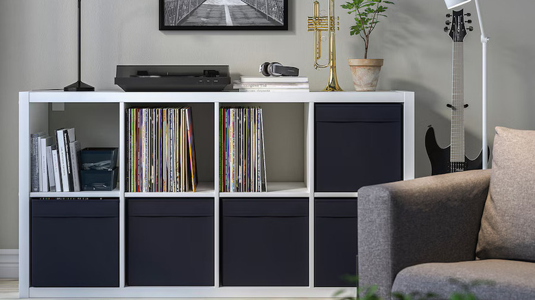 A cube storage unit with black fabric boxes