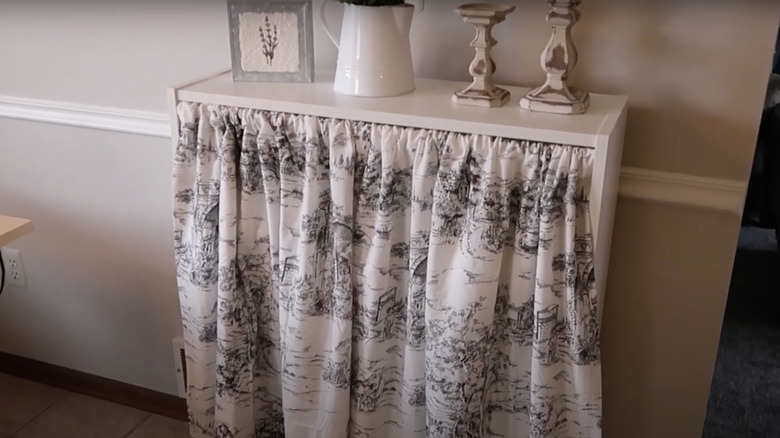 toile café curtain on a shelf