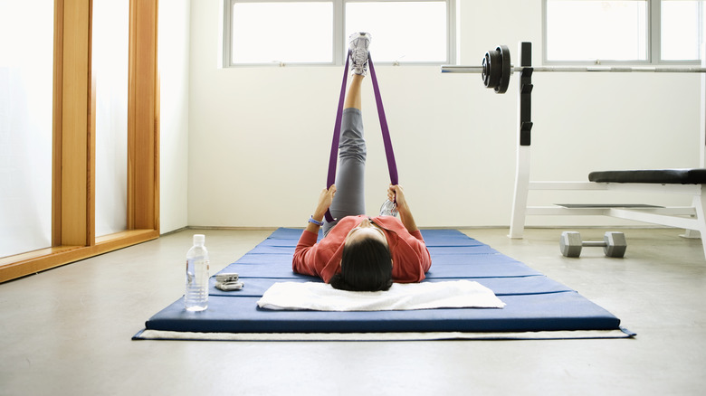 person laying on gymnastics mat