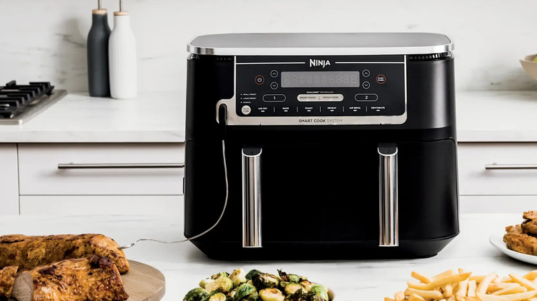 black Ninja air fryer with cooked ready-to-eat food