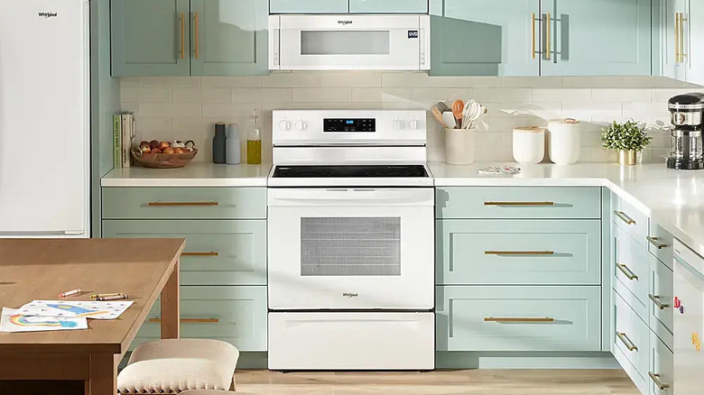 White electric range microwave set in pastel classic kitchen