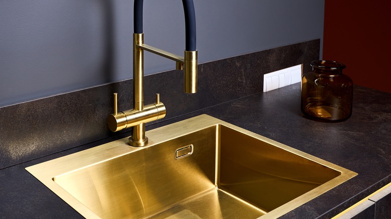 gold kitchen sink and matching faucet