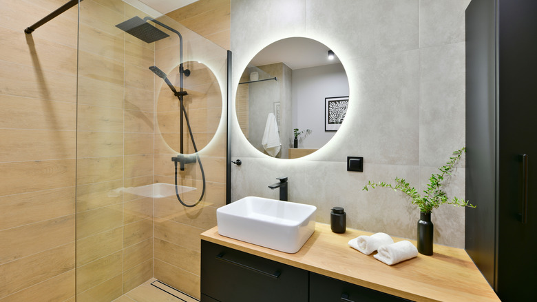 LED lighting in windowless bathroom with round backlit mirror