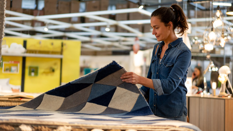 Woman looking at carpets