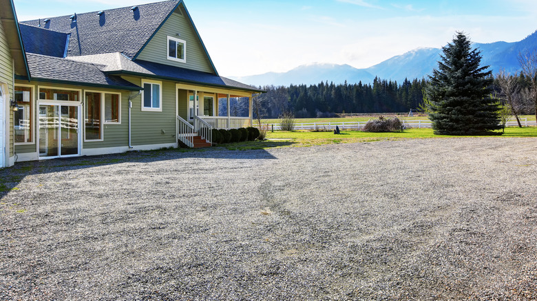 Home with a large gravel driveway