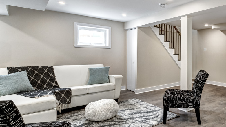 Basement seating area with small window  and neutral decor