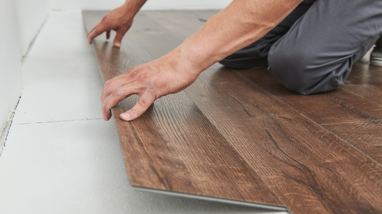 Man installing vinyl flooring