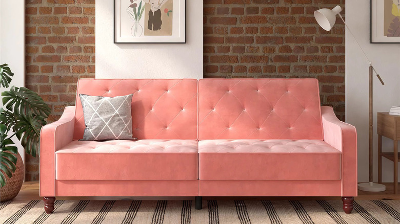 Pink sofa with brick wall